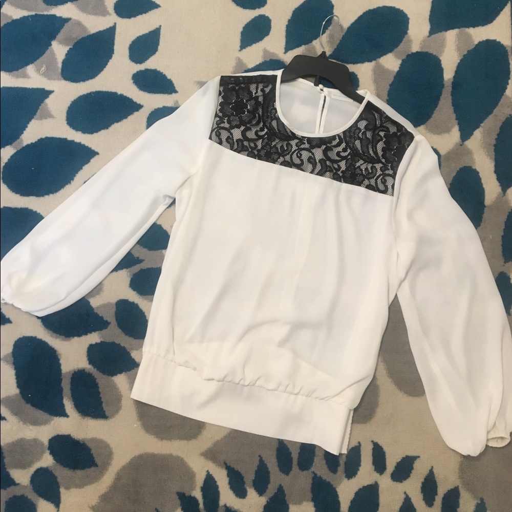 Never worn. White and black top.